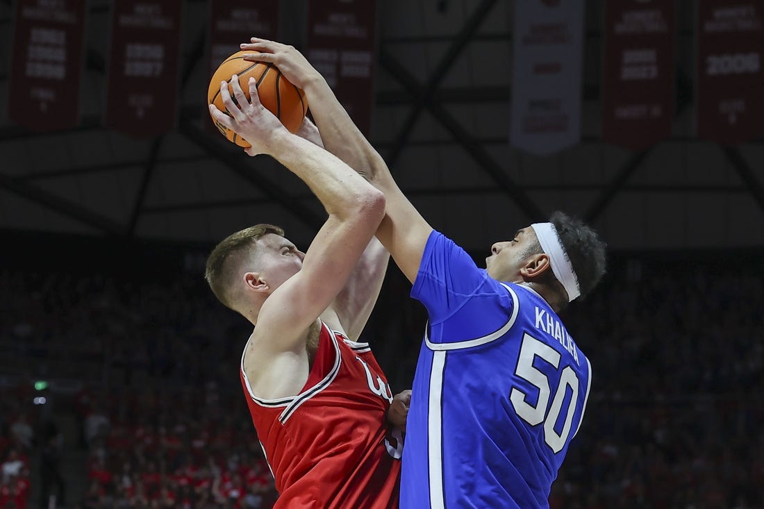 Dec 9, 2023; Salt Lake City, Utah, USA; Brigham Young Cougars center Aly Khalifa (50) blocks the shot of Utah Utes center Lawson Lovering (34) during the second half at Jon M. Huntsman Center. Mandatory Credit: Rob Gray-USA TODAY Sports