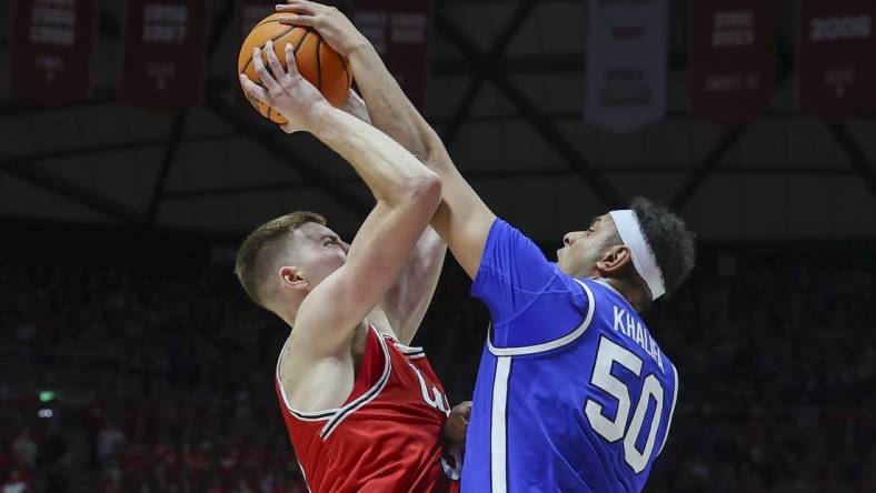 Dec 9, 2023; Salt Lake City, Utah, USA; Brigham Young Cougars center Aly Khalifa (50) blocks the shot of Utah Utes center Lawson Lovering (34) during the second half at Jon M. Huntsman Center. Mandatory Credit: Rob Gray-USA TODAY Sports