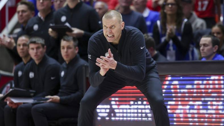 Dec 9, 2023; Salt Lake City, Utah, USA; Brigham Young Cougars head coach Mark Pope encourages the team against the Utah Utes during the second half at Jon M. Huntsman Center. Mandatory Credit: Rob Gray-USA TODAY Sports