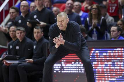 Dec 9, 2023; Salt Lake City, Utah, USA; Brigham Young Cougars head coach Mark Pope encourages the team against the Utah Utes during the second half at Jon M. Huntsman Center. Mandatory Credit: Rob Gray-USA TODAY Sports