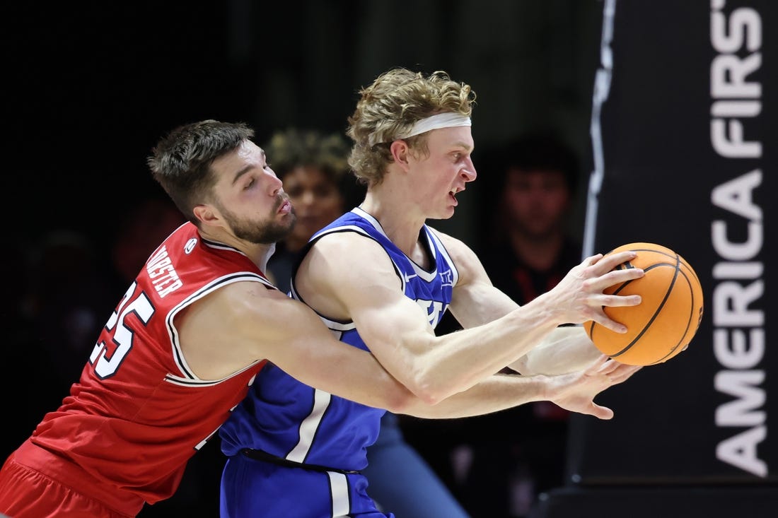 Dec 9, 2023; Salt Lake City, Utah, USA; Utah Utes guard Rollie Worster (25) and Brigham Young Cougars guard Richie Saunders (15) battle for the ball during the second half at Jon M. Huntsman Center. Mandatory Credit: Rob Gray-USA TODAY Sports