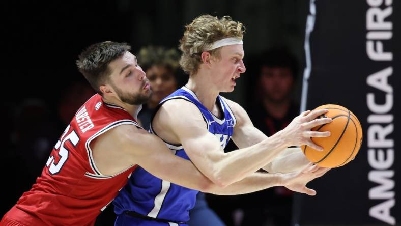 Dec 9, 2023; Salt Lake City, Utah, USA; Utah Utes guard Rollie Worster (25) and Brigham Young Cougars guard Richie Saunders (15) battle for the ball during the second half at Jon M. Huntsman Center. Mandatory Credit: Rob Gray-USA TODAY Sports