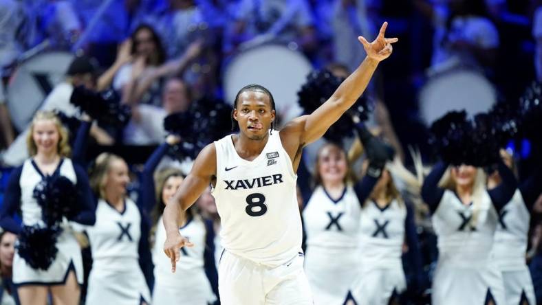 Dec 9, 2023; Cincinnati, Ohio, USA; Xavier Musketeers guard Quincy Olivari (8) reacts after a made three-point basket in the second half against the Cincinnati Bearcats at Cintas Center. Mandatory Credit: Albert Cesare/The Enquirer-USA TODAY Sports