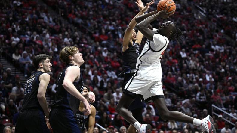 Dec 9, 2023; San Diego, California, USA; San Diego State Aztecs forward Jay Pal (4) shoots the ball against UC Irvine Anteaters guard Andre Henry (4) during the first half at Viejas Arena. Mandatory Credit: Orlando Ramirez-USA TODAY Sports