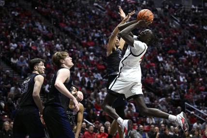 Dec 9, 2023; San Diego, California, USA; San Diego State Aztecs forward Jay Pal (4) shoots the ball against UC Irvine Anteaters guard Andre Henry (4) during the first half at Viejas Arena. Mandatory Credit: Orlando Ramirez-USA TODAY Sports