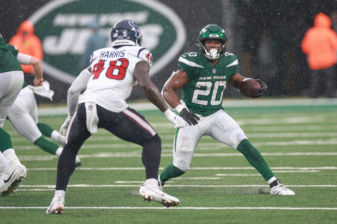 Dec 10, 2023; East Rutherford, New Jersey, USA; New York Jets running back Breece Hall (20) carries the ball asHouston Texans linebacker Christian Harris (48) pursues during the first half at MetLife Stadium. Mandatory Credit: Vincent Carchietta-USA TODAY Sports