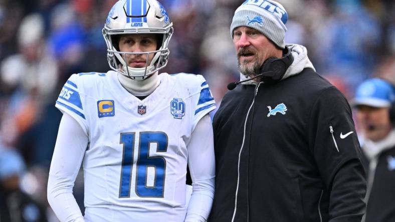 Dec 10, 2023; Chicago, Illinois, USA;  Detroit Lions head coach Dan Campbell talks with quarterback Jared Goff (16) in the first half against the Chicago Bears at Soldier Field. Mandatory Credit: Jamie Sabau-USA TODAY Sports