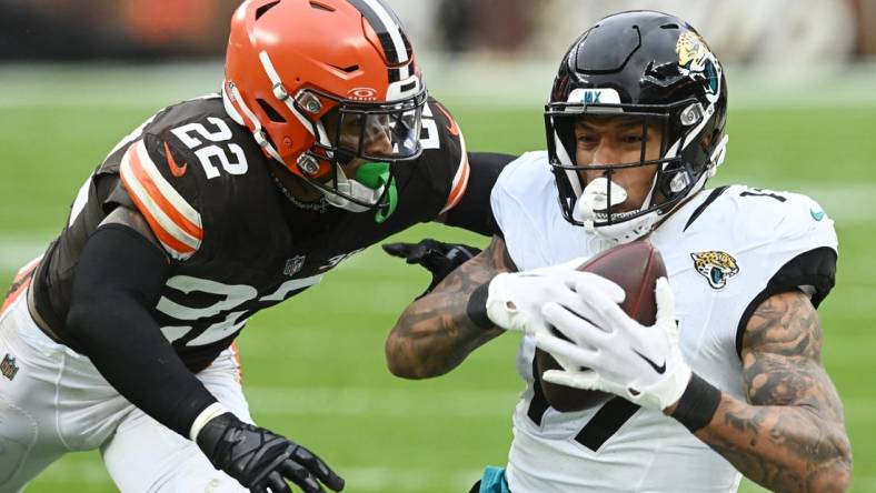 Dec 10, 2023; Cleveland, Ohio, USA; Jacksonville Jaguars tight end Evan Engram (17) catches a pass as Cleveland Browns safety Grant Delpit (22) defends during the first half at Cleveland Browns Stadium. Mandatory Credit: Ken Blaze-USA TODAY Sports