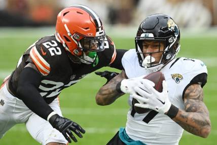 Dec 10, 2023; Cleveland, Ohio, USA; Jacksonville Jaguars tight end Evan Engram (17) catches a pass as Cleveland Browns safety Grant Delpit (22) defends during the first half at Cleveland Browns Stadium. Mandatory Credit: Ken Blaze-USA TODAY Sports