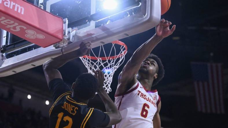 Dec 10, 2023; Los Angeles, California, USA; USC Trojans guard Bronny James (6) blocks a shot by Long Beach State 49ers guard Jadon Jones (12) in the first half at Galen Center. It was James  first game of the season since suffering a near fatal heat attack. Mandatory Credit: Robert Hanashiro-USA TODAY Sports