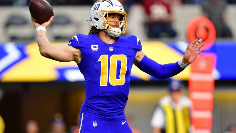 Dec 10, 2023; Inglewood, California, USA; Los Angeles Chargers quarterback Justin Herbert (10) throws against the Denver Broncos during the first half at SoFi Stadium. Mandatory Credit: Gary A. Vasquez-USA TODAY Sports