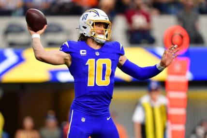 Dec 10, 2023; Inglewood, California, USA; Los Angeles Chargers quarterback Justin Herbert (10) throws against the Denver Broncos during the first half at SoFi Stadium. Mandatory Credit: Gary A. Vasquez-USA TODAY Sports