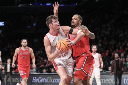 Dec 10, 2023; Brooklyn, New York, USA; Boston College Eagles forward Quinten Post (12) looks to post up against St. John's Red Storm center Joel Soriano (11) in the second half at Barclays Center. Mandatory Credit: Wendell Cruz-USA TODAY Sports