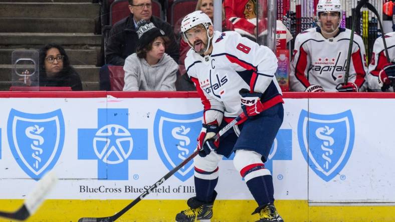 Dec 10, 2023; Chicago, Illinois, USA; Washington Capitals left wing Alex Ovechkin (8) plays the puck against the Chicago Blackhawks during the first period at the United Center. Mandatory Credit: Daniel Bartel-USA TODAY Sports