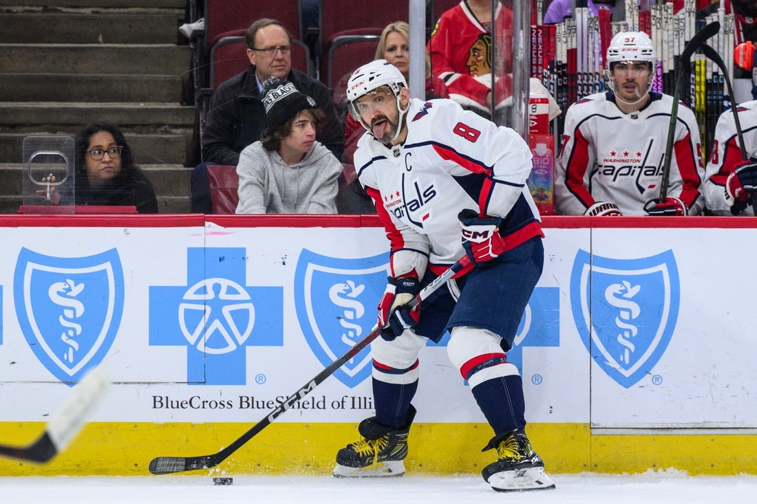 Dec 10, 2023; Chicago, Illinois, USA; Washington Capitals left wing Alex Ovechkin (8) plays the puck against the Chicago Blackhawks during the first period at the United Center. Mandatory Credit: Daniel Bartel-USA TODAY Sports