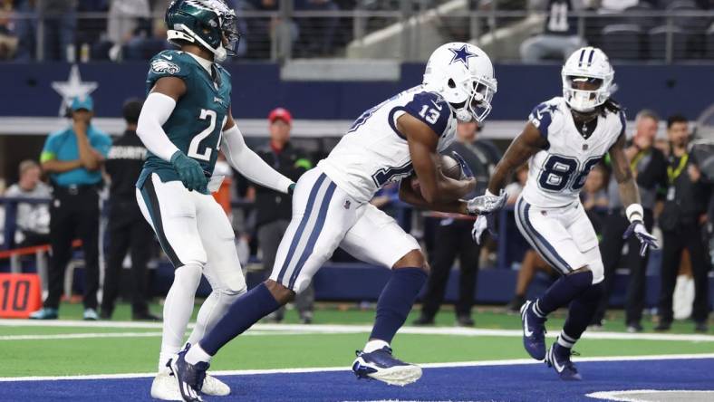 Dec 10, 2023; Arlington, Texas, USA; Dallas Cowboys wide receiver Michael Gallup (13) catches a touchdown pass against Philadelphia Eagles cornerback James Bradberry (24) in the second quarter at AT&T Stadium. Mandatory Credit: Tim Heitman-USA TODAY Sports