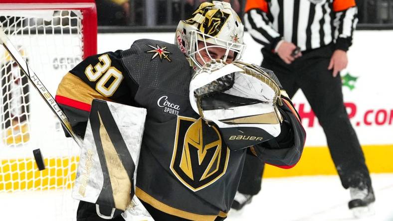 Dec 10, 2023; Las Vegas, Nevada, USA; Vegas Golden Knights goaltender Jiri Patera (30) makes a save against the San Jose Sharks during the first period at T-Mobile Arena. Mandatory Credit: Stephen R. Sylvanie-USA TODAY Sports