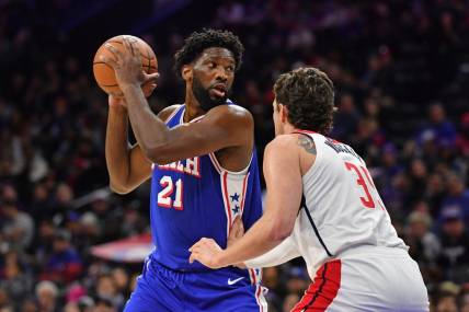 Dec 11, 2023; Philadelphia, Pennsylvania, USA; Philadelphia 76ers center Joel Embiid (21) is defended by Washington Wizards center Mike Muscala (35) during the first quarter at Wells Fargo Center. Mandatory Credit: Eric Hartline-USA TODAY Sports