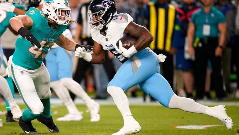 Tennessee Titans wide receiver Treylon Burks (16) is stopped by Miami Dolphins linebacker Andrew Van Ginkel (43) during the first quarter at Hard Rock Stadium in Miami, Fla., Monday, Dec. 11, 2023.