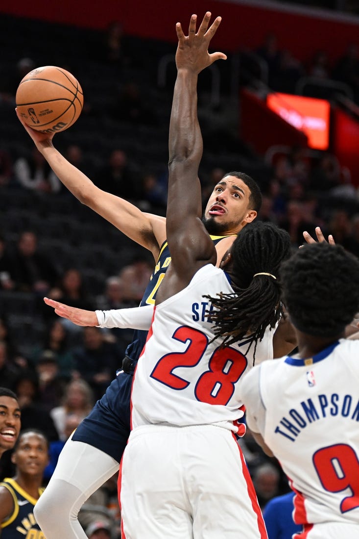 Dec 11, 2023; Detroit, Michigan, USA;  Indiana Pacers guard Tyrese Haliburton (0) shoots over Detroit Pistons center Isaiah Stewart (28) in the first quarter at Little Caesars Arena. Mandatory Credit: Lon Horwedel-USA TODAY Sports