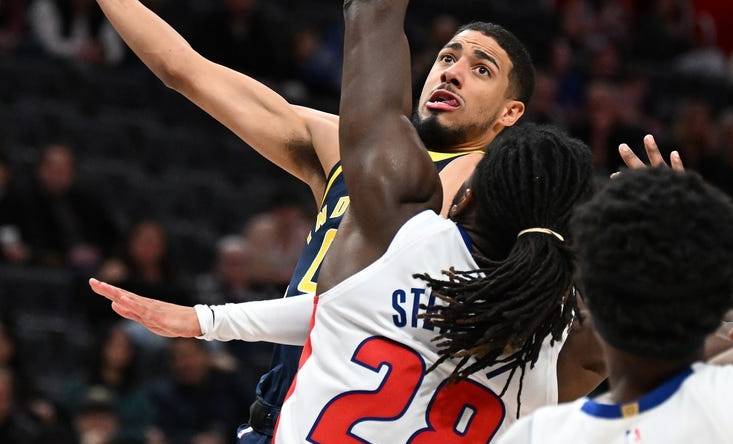 Dec 11, 2023; Detroit, Michigan, USA;  Indiana Pacers guard Tyrese Haliburton (0) shoots over Detroit Pistons center Isaiah Stewart (28) in the first quarter at Little Caesars Arena. Mandatory Credit: Lon Horwedel-USA TODAY Sports