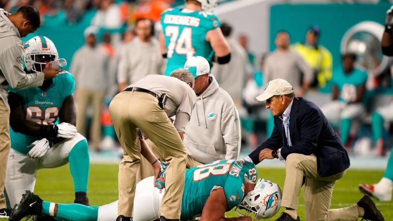 Miami Dolphins guard Connor Williams (58) is check out by staff during the first quarter against the Tennessee Titans at Hard Rock Stadium in Miami, Fla., Monday, Dec. 11, 2023.