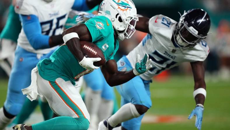 Dec 11, 2023; Miami Gardens, Florida, USA; Miami Dolphins wide receiver Tyreek Hill (10) runs with the ball against the Tennessee Titans during the first half at Hard Rock Stadium. Mandatory Credit: Jasen Vinlove-USA TODAY Sports