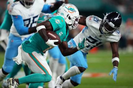 Dec 11, 2023; Miami Gardens, Florida, USA; Miami Dolphins wide receiver Tyreek Hill (10) runs with the ball against the Tennessee Titans during the first half at Hard Rock Stadium. Mandatory Credit: Jasen Vinlove-USA TODAY Sports