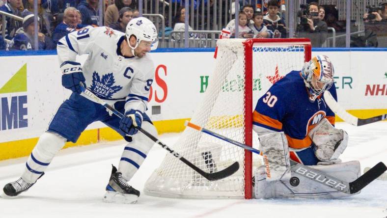 Dec 11, 2023; Elmont, New York, USA; Toronto Maple Leafs center John Tavares (91) takes a shot while New York Islanders goaltender Ilya Sorokin (30) makes the save during the third period at UBS Arena. Mandatory Credit: Thomas Salus-USA TODAY Sports