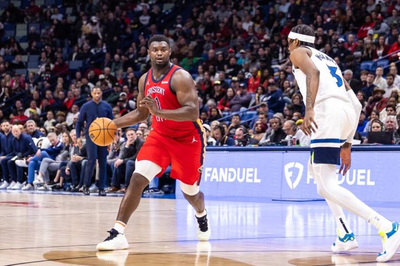 Dec 11, 2023; New Orleans, Louisiana, USA; New Orleans Pelicans forward Zion Williamson (1) dribbles against Minnesota Timberwolves forward Jaden McDaniels (3) during the second half at the Smoothie King Center. Mandatory Credit: Stephen Lew-USA TODAY Sports