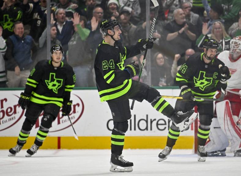 Dec 11, 2023; Dallas, Texas, USA; Dallas Stars center Roope Hintz (24) and left wing Jason Robertson (21) and left wing Jamie Benn (14) celebrates a goal scored by center Joe Pavelski (not pictured) against the Detroit Red Wings during the third period at the American Airlines Center. Mandatory Credit: Jerome Miron-USA TODAY Sports