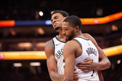 Dec 11, 2023; Sacramento, California, USA; Brooklyn Nets center Nic Claxton (33) and forward Mikal Bridges (1) embrace after a called foul during the fourth quarter against the Sacramento Kings at Golden 1 Center. Mandatory Credit: Ed Szczepanski-USA TODAY Sports