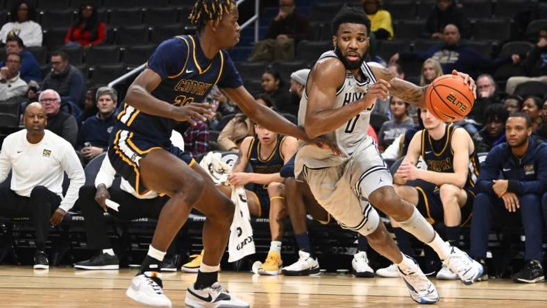 Dec 12, 2023; Washington, District of Columbia, USA; Georgetown Hoyas guard Dontrez Styles (0) dribbles past Coppin State Eagles forward Toto Fagbenle (20) during the first half at Capital One Arena. Mandatory Credit: Brad Mills-USA TODAY Sports