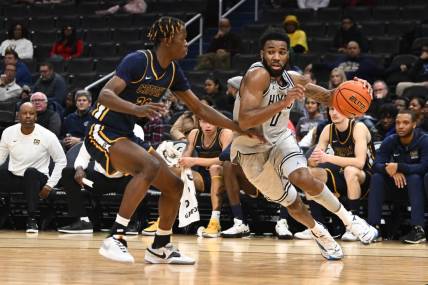 Dec 12, 2023; Washington, District of Columbia, USA; Georgetown Hoyas guard Dontrez Styles (0) dribbles past Coppin State Eagles forward Toto Fagbenle (20) during the first half at Capital One Arena. Mandatory Credit: Brad Mills-USA TODAY Sports