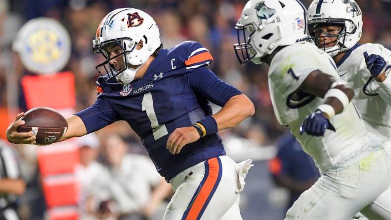 Auburn Tigers quarterback Payton Thorne (1) stretches the ball out as he crosses the goalline for a touchdown against Samford Bulldogs defensive back Kourtlan Marsh (1) during second half action in the AU vs. Samford game at Jordan-Hare Stadium in the AU campus in Auburn, Ala., on Saturday September 16, 2023.