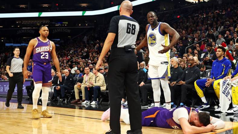 Dec 12, 2023; Phoenix, Arizona, USA; Golden State Warriors forward Draymond Green (23) reacts after being called for a foul on Phoenix Suns center Jusuf Nurkic (20) during the third quarter at Footprint Center. Mandatory Credit: Mark J. Rebilas-USA TODAY Sports