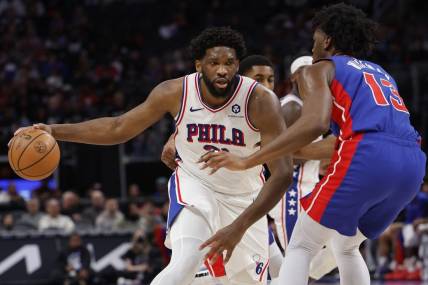 Dec 13, 2023; Detroit, Michigan, USA;  Philadelphia 76ers center Joel Embiid (21) is defended by Detroit Pistons center James Wiseman (13) in the first half at Little Caesars Arena. Mandatory Credit: Rick Osentoski-USA TODAY Sports