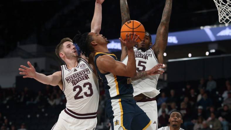 Dec 13, 2023; Starkville, Mississippi, USA; Murray State Racers guard JaCobi Wood (24) drives to the basket as Mississippi State Bulldogs guard Andrew Taylor (23) and forward Jimmy Bell Jr. (15) defends during the first half at Humphrey Coliseum. Mandatory Credit: Petre Thomas-USA TODAY Sports