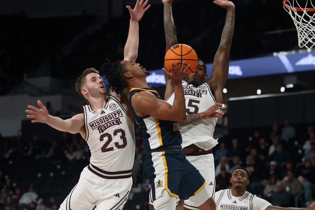 Dec 13, 2023; Starkville, Mississippi, USA; Murray State Racers guard JaCobi Wood (24) drives to the basket as Mississippi State Bulldogs guard Andrew Taylor (23) and forward Jimmy Bell Jr. (15) defends during the first half at Humphrey Coliseum. Mandatory Credit: Petre Thomas-USA TODAY Sports