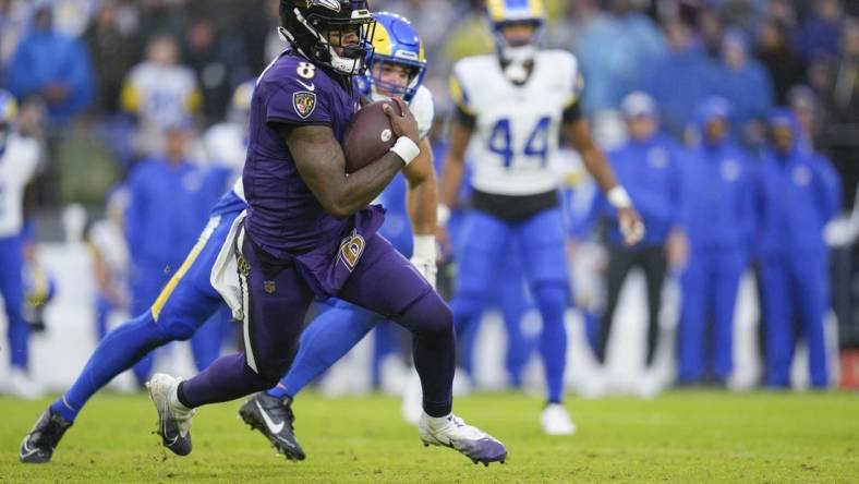 Dec 10, 2023; Baltimore, Maryland, USA;  Baltimore Ravens quarterback Lamar Jackson (8) runs with the ball against the Los Angeles Rams during the second half at M&T Bank Stadium. Mandatory Credit: Jessica Rapfogel-USA TODAY Sports