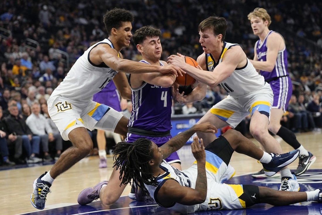 Dec 14, 2023; Milwaukee, Wisconsin, USA;  St. Thomas (MN) Tommies forward Brooks Allen (4) battles Marquette Golden Eagles forward Oso Ighodaro (13) and guard Tyler Kolek (11) for control of the ball during the first half at Fiserv Forum. Mandatory Credit: Jeff Hanisch-USA TODAY Sports