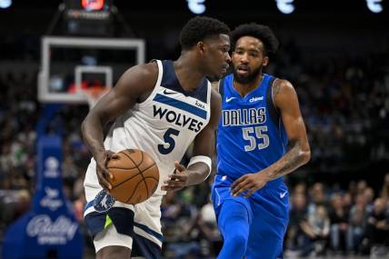Dec 14, 2023; Dallas, Texas, USA; Minnesota Timberwolves guard Anthony Edwards (5) looks to move the ball past Dallas Mavericks forward Derrick Jones Jr. (55) during the first quarter at the American Airlines Center. Mandatory Credit: Jerome Miron-USA TODAY Sports