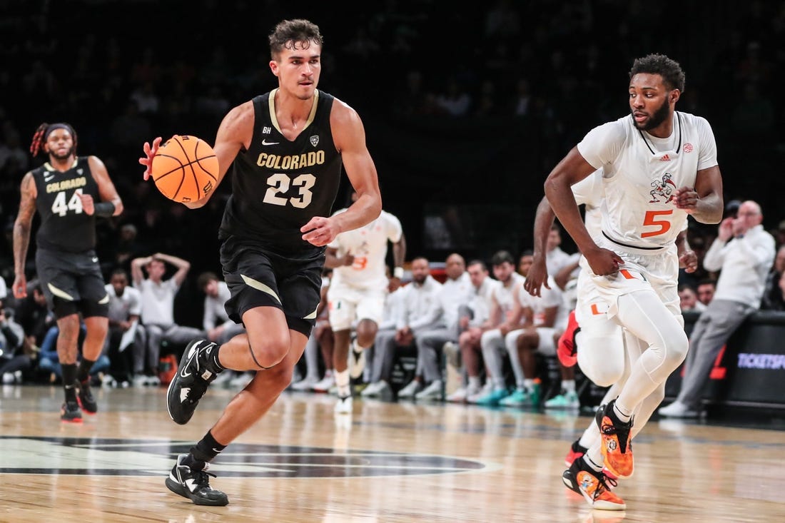 Dec 10, 2023; Brooklyn, New York, USA;  Colorado Buffaloes forward Tristan da Silva (23) and Miami (Fl) Hurricanes guard Wooga Poplar (5) at Barclays Center. Mandatory Credit: Wendell Cruz-USA TODAY Sports