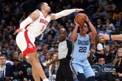Dec 15, 2023; Memphis, Tennessee, USA; Memphis Grizzlies guard Desmond Bane (22) shoots for three as Houston Rockets  forward Dillon Brooks (9) defends during the first half at FedExForum. Mandatory Credit: Petre Thomas-USA TODAY Sports