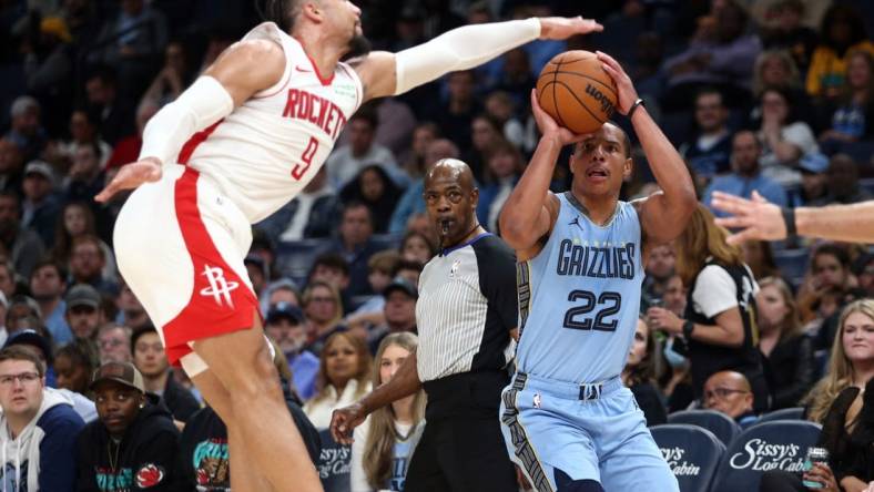 Dec 15, 2023; Memphis, Tennessee, USA; Memphis Grizzlies guard Desmond Bane (22) shoots for three as Houston Rockets  forward Dillon Brooks (9) defends during the first half at FedExForum. Mandatory Credit: Petre Thomas-USA TODAY Sports