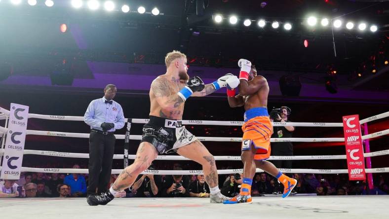 Dec 15, 2023; Orlando, Florida, USA;  Jake Paul fights Andre August in the first round at the Caribe Royale Orlando. Mandatory Credit: Nathan Ray Seebeck-USA TODAY Sports