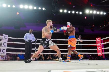Dec 15, 2023; Orlando, Florida, USA;  Jake Paul fights Andre August in the first round at the Caribe Royale Orlando. Mandatory Credit: Nathan Ray Seebeck-USA TODAY Sports