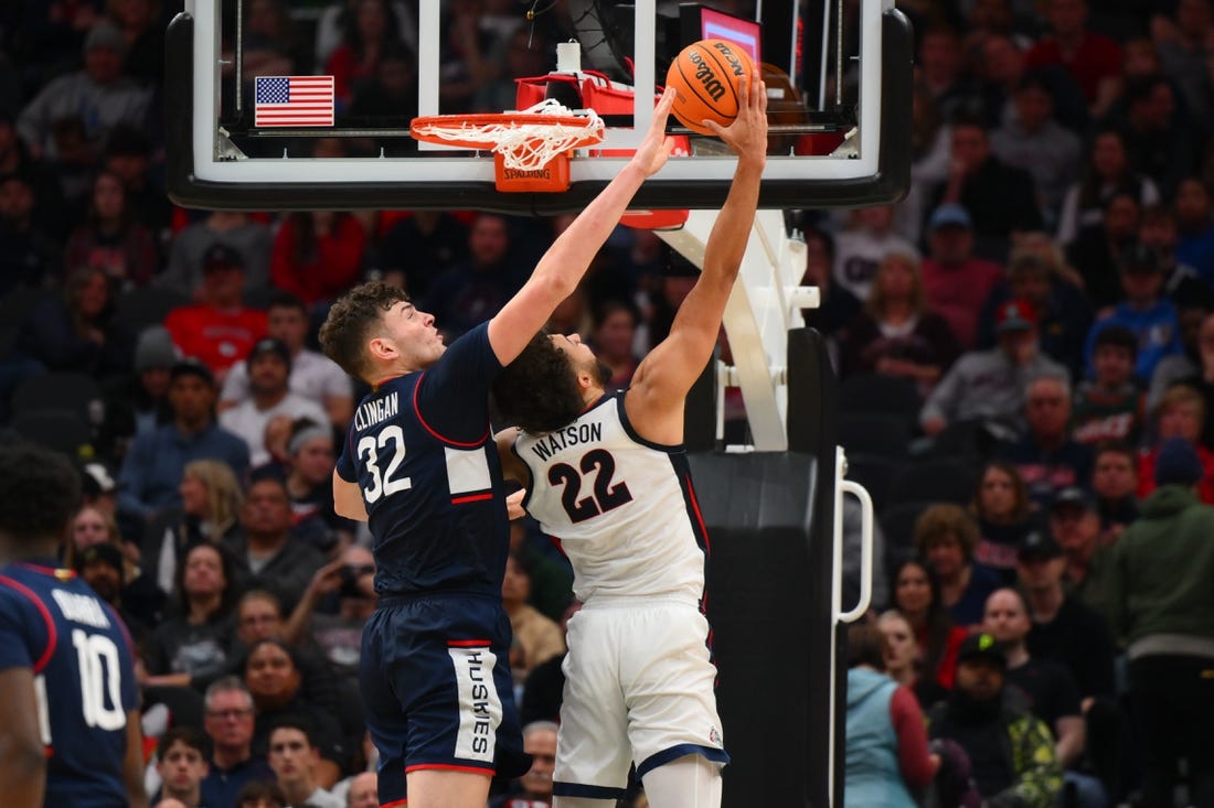 Dec 15, 2023; Seattle, Washington, USA; Connecticut Huskies center Donovan Clingan (32) blocks a shot attempt by Gonzaga Bulldogs forward Anton Watson (22) during the second half at Climate Pledge Arena. Mandatory Credit: Steven Bisig-USA TODAY Sports