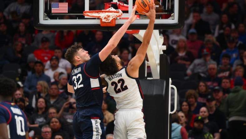 Dec 15, 2023; Seattle, Washington, USA; Connecticut Huskies center Donovan Clingan (32) blocks a shot attempt by Gonzaga Bulldogs forward Anton Watson (22) during the second half at Climate Pledge Arena. Mandatory Credit: Steven Bisig-USA TODAY Sports