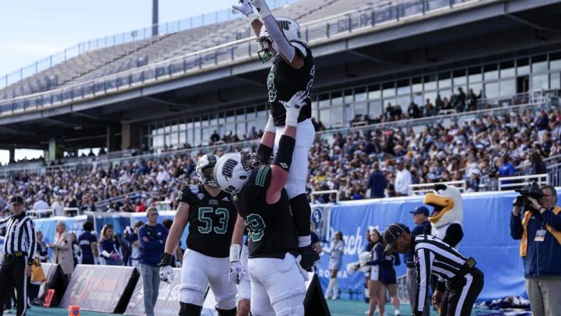 Dec 16, 2023; Conway, SC, USA; Ohio Bobcats running back Rickey Hunt (28) is lifted into the air by Ohio Bobcats offensive lineman Parker Titsworth (69) after a touchdown in the first half against the Georgia Southern Eagles at Brooks Stadium. Mandatory Credit: David Yeazell-USA TODAY Sports